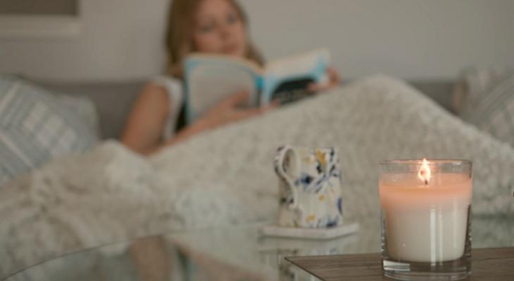 Person reading by candlelight