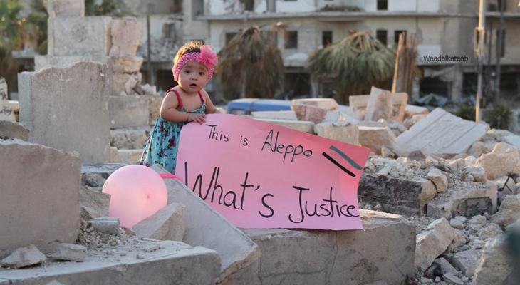 A child holding a sign in the movie For Sama