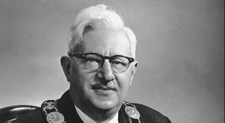 man wearing glasses and mayor's necklace