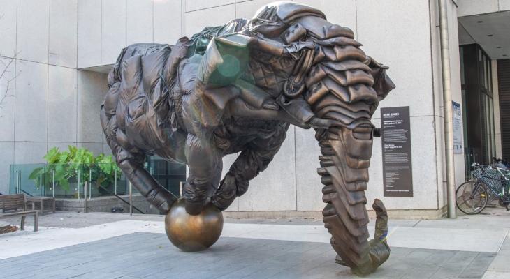 A statue of an elephant balancing on a ball