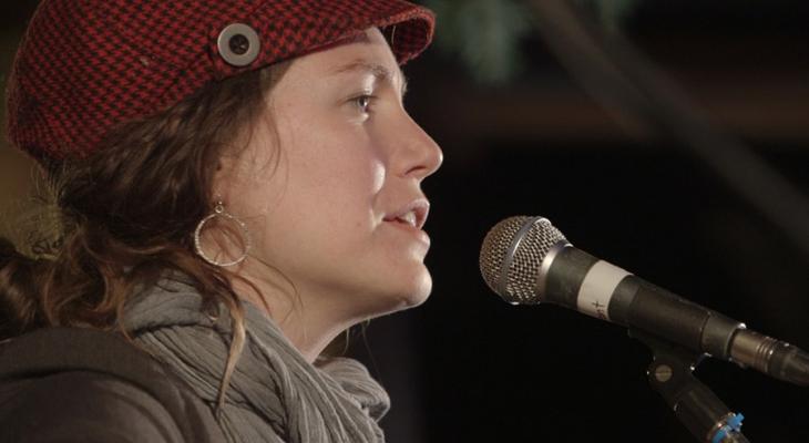 Woman singing into a microphone