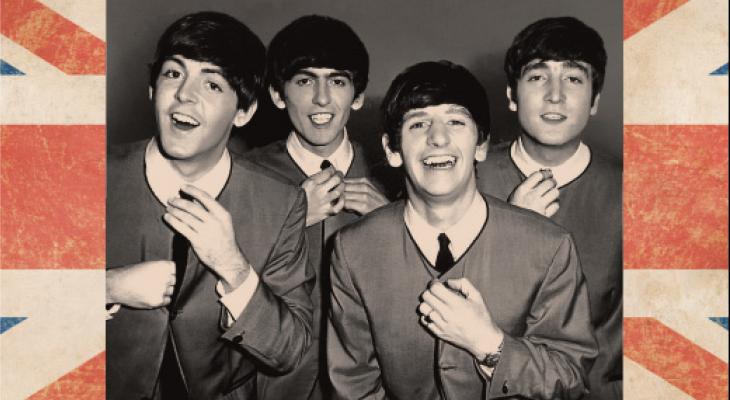 Black and white photo of the beatles, with border of the British flag