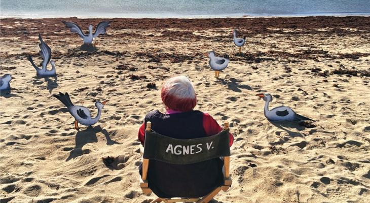 Agnès Varda sitting on a beach