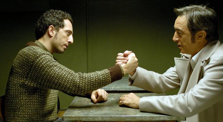 two men facing each other and arm wrestling