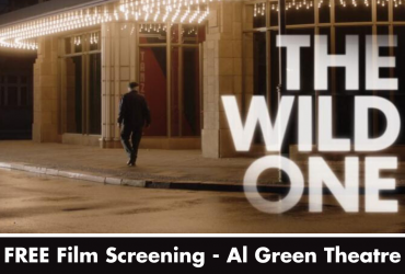a photo of someone walking into a lit-up theatre with the words "the wild one: free film screening - al green theatre" written overtop