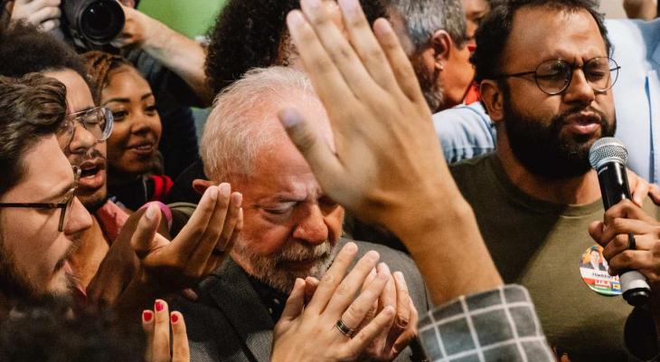 a man praying while surround by people