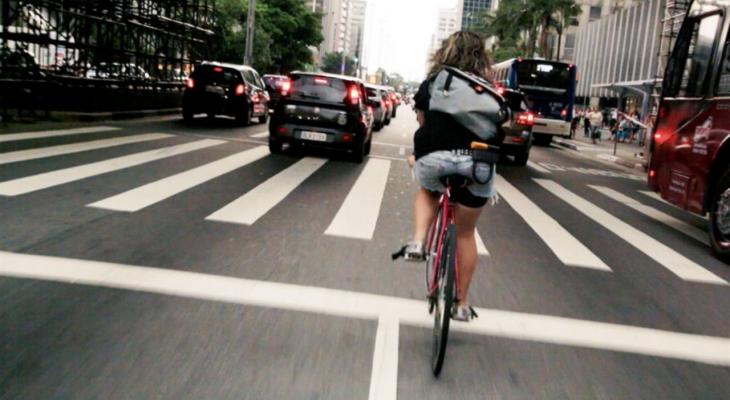 Person biking down city street