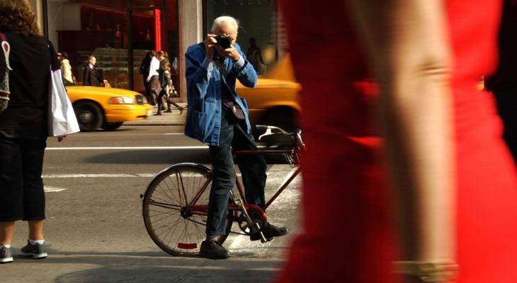 person on a bicycle taking a photo