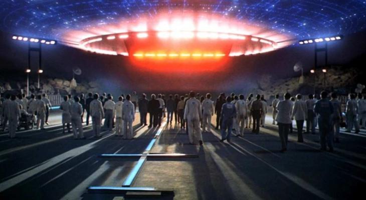 a group of people looking up at a spaceship