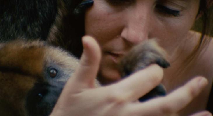 a woman holding a monkey's paw in her hand