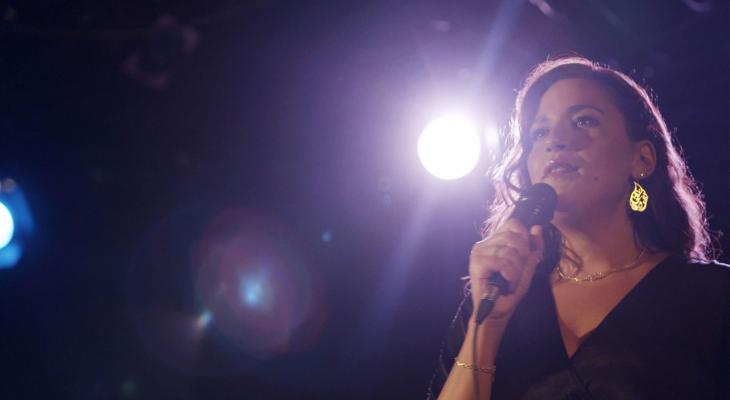 a woman speaking into a microphone
