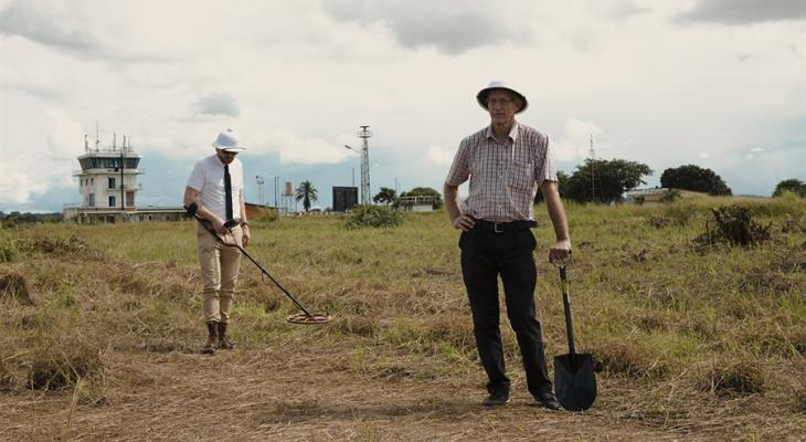 Two people standing in a field