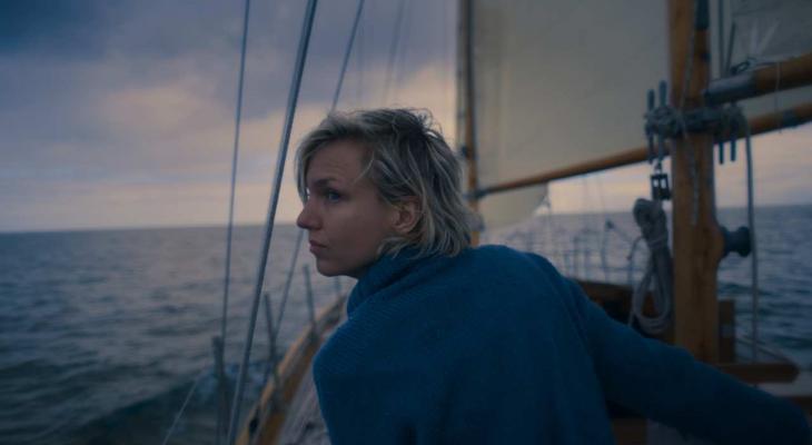 a woman looking over her shoulder on a sailboat