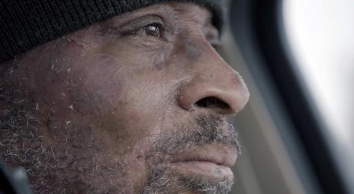 Close up of Dwayne Lee as he looks out a car window. 