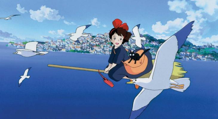 a young with and a cat on a broom
