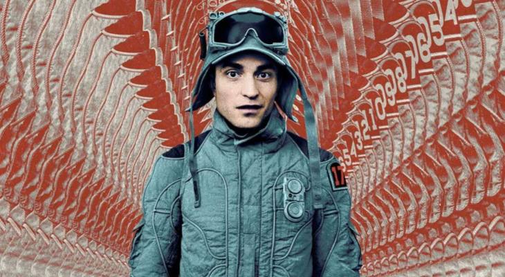 Robert Pattinson in military uniform in front of red patterned fabric