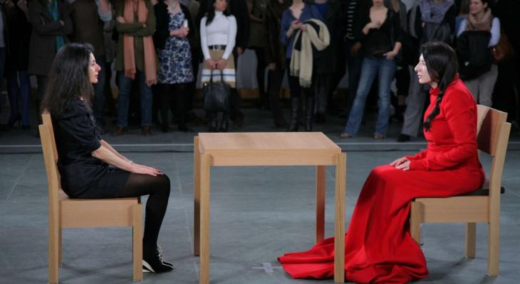 two people sitting in chairs on opposite sides of a table