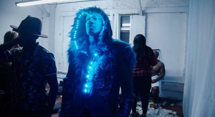 a man in a fur trimmed hood adorned with string lights