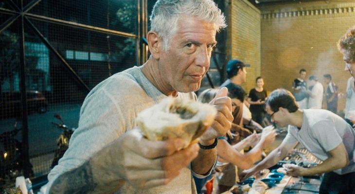 a person holding food to the camera