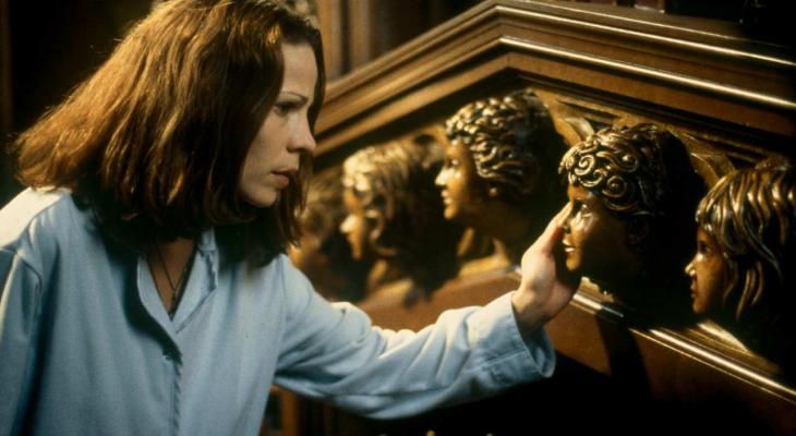 Lili Taylor looking at a staircase with carved faces