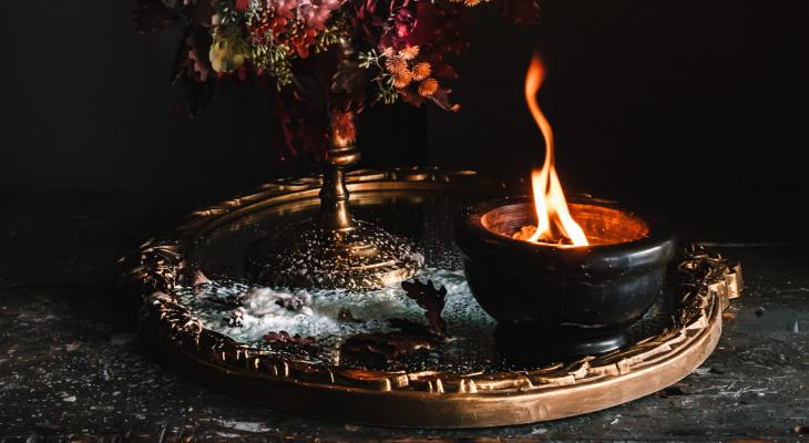 Close up image of a candle and a flower bouqet