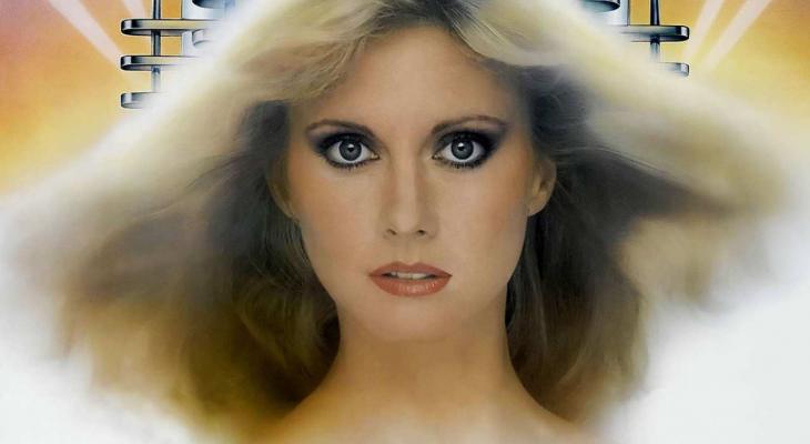 Olivia Newton-John with her hair blowing in the wind and dark eyeliner