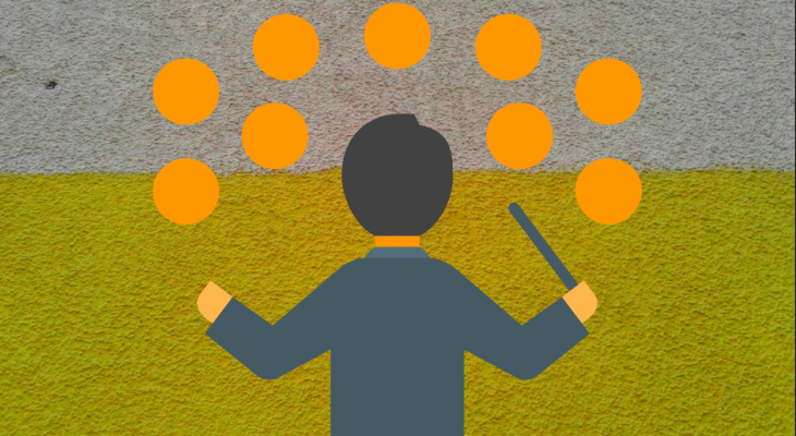 A man holding a conductor's wand facing orange blobs representing people