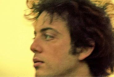 Billy Joel looking to the left
