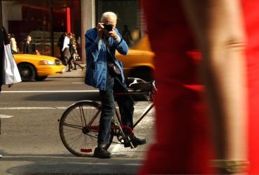 person on a bicycle taking a photo
