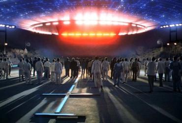 a group of people looking up at a spaceship