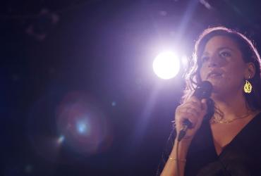 a woman speaking into a microphone