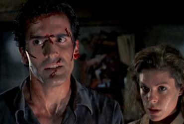 Bruce Campbell with cuts on his face standing next to a woman