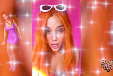 a young woman with orange hair and white sunglasses