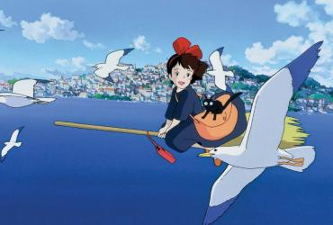 a young with and a cat on a broom