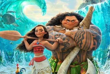 Moana and Maui standing together in front of waves