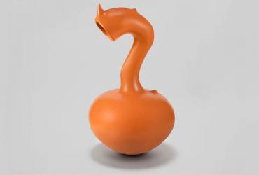 An orange ceramic vessel with a round belly and curved neck