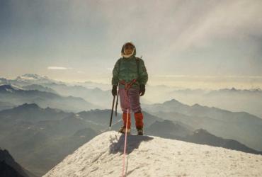 a woman standing on a mountain