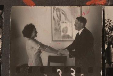 a woman holding hands with a man and smiling