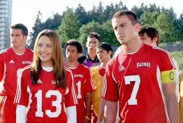 a teenage girl and boy with a soccer team