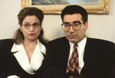 Linda Kash and Eugene Levy observe something questionable offscreen.