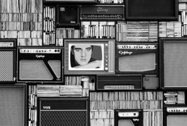 Black and white collage of vintage speakers and records. One television in the centre displays an image of Elvis Presley.  