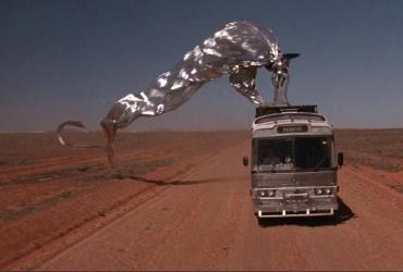 Adorned with silver streamers, Priscilla the bus makes her way through the Aussie desert.