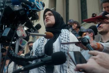 A woman speaks at a protest in solidarity with the Palestinian struggle.